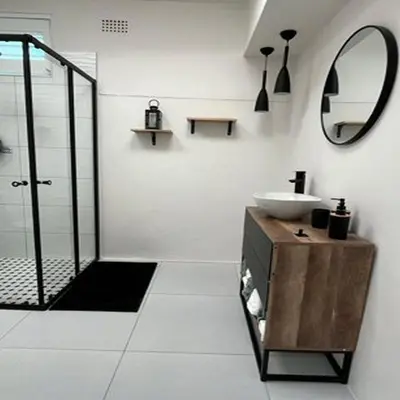a white bathroom with a sink and a mirror at 64 On Forest in Cape Town