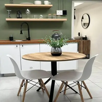 a kitchen with a table with a vase of flowers on it at 64 On Forest in Cape Town