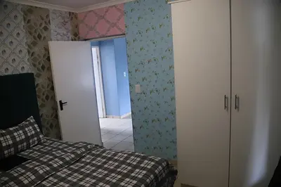 a bedroom with a bed and a door to a hallway at Browns villa in Cape Town