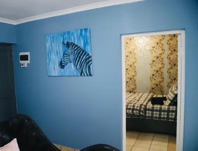 a room with a painting of a zebra on the wall at Browns villa in Cape Town