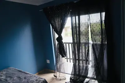 a window with black curtains in a room at Browns villa in Cape Town
