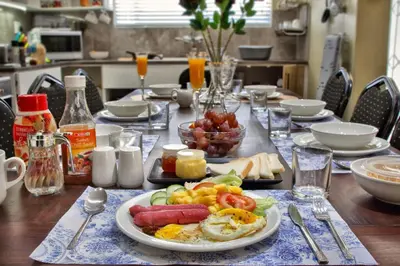 a table with a plate of breakfast food on it at Camdene Guesthouse in Cape Town