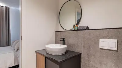 a bathroom with a sink and a mirror on a counter at Table Mountain View Apartment in Cape Town