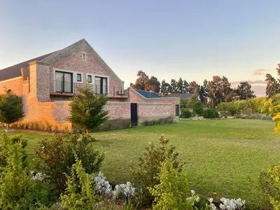 a brick house with a lawn in front of it at Beertjie Bos in Paarl