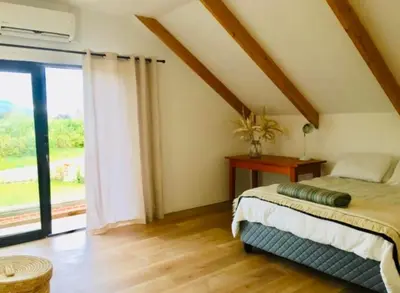 a bedroom with a bed and a large window at Beertjie Bos in Paarl