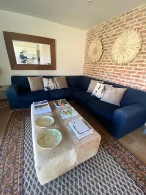 a living room with a blue couch and a table at Beertjie Bos in Paarl