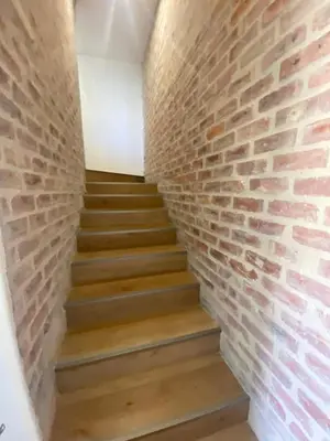a brick wall and stairs in a hallway at Beertjie Bos in Paarl