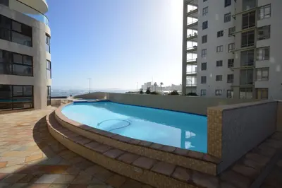 a swimming pool on the side of a building at 402 Ocean View in Strand