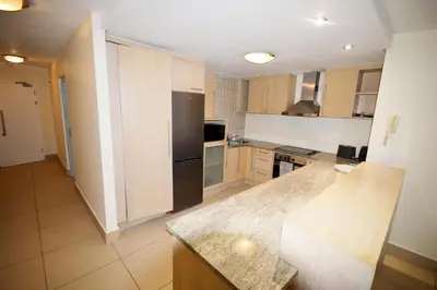a kitchen with a stainless steel refrigerator and cabinets at 402 Ocean View in Strand