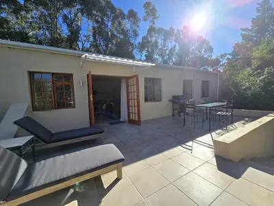 a house with a patio with a table and chairs at Susans Cottage Peace and Quiet in Villiersdorp