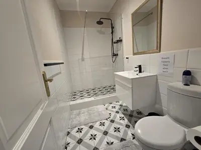 a white bathroom with a toilet and a sink at Susans Cottage Peace and Quiet in Villiersdorp