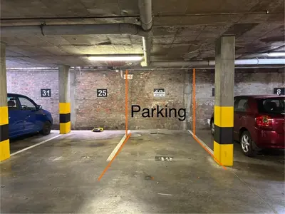 a parking garage with two cars parked in it at Modern living in central town in Stellenbosch