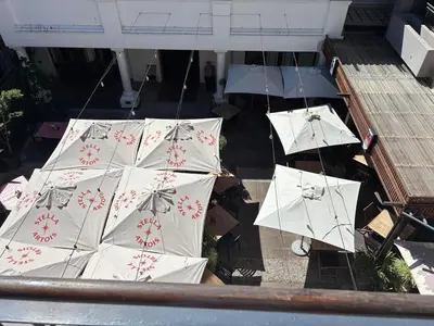 a group of white umbrellas on the ground at Modern living in central town in Stellenbosch