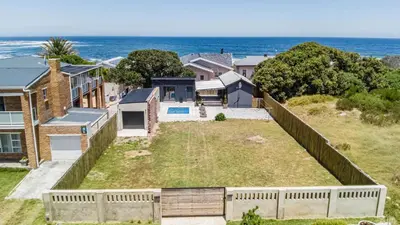 an aerial view of a house with the ocean in the background at Cozy Cottage in Hermanus