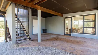 an empty room with a staircase in a house at BluCabana 500m from Main Beach in Bettyʼs Bay
