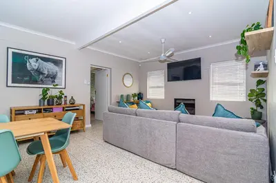a living room with a couch and a table at Pikkewyn Paradise in Hermanus