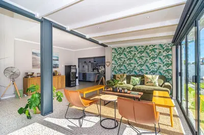 a living room with a couch and chairs at Pikkewyn Paradise in Hermanus