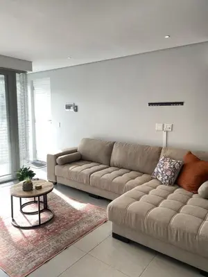 a living room with a couch and a table at Boerbok & Bloom in Paarl