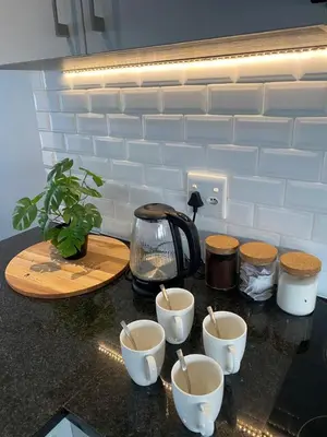 a counter with four cups and a tea kettle on it at Boerbok & Bloom in Paarl