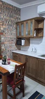 a kitchen with wooden cabinets and a wooden table at Firehouse guest suite no 3 in Wellington