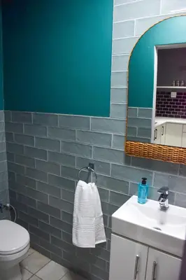 a bathroom with a toilet and a sink and a mirror at Blade Flatlet in Silver Sands