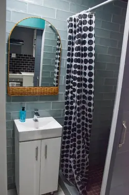 a bathroom with a sink and a mirror and a shower at Blade Flatlet in Silver Sands