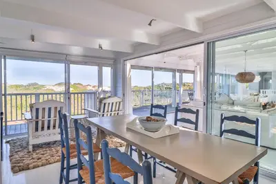 a dining room with a table and chairs at Nordic Family Beach House in Bettyʼs Bay