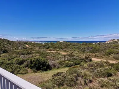 a view of the ocean from the balcony of a house at Nordic Family Beach House in Bettyʼs Bay