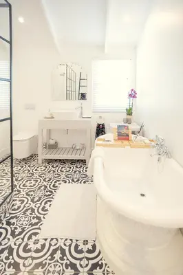 a white bathroom with a tub and a sink at Roubaix House - A Heritage Retreat in the Heart of Franschhoek in Franschhoek