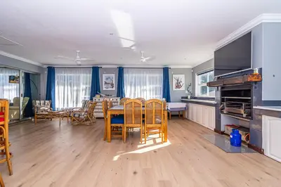 a kitchen and dining room with a table and chairs at Four Pines in Hermanus