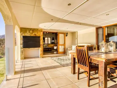 a dining room with a wooden table and chairs at Blue Crane House