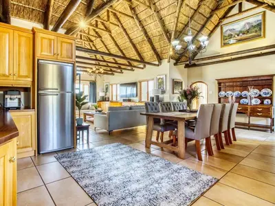 a kitchen and dining room with a table and refrigerator at Blue Crane House