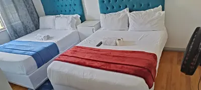 a hotel room with two beds with towels on them at PEACEFUL SLEEP lodge in Goodwood