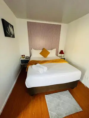 a bedroom with a large bed in a room at Kay's Guest Apartments in Kraaifontein
