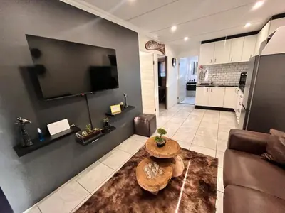 a living room with a couch and a table at Casa Bracken in Windsor Park