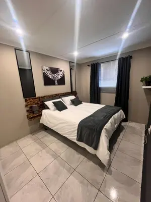 a bedroom with a large bed with lights on it at Casa Bracken in Windsor Park