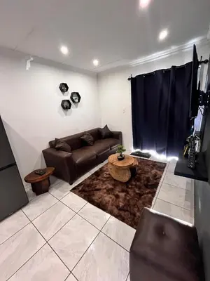 a living room with a couch and a table at Casa Bracken in Windsor Park