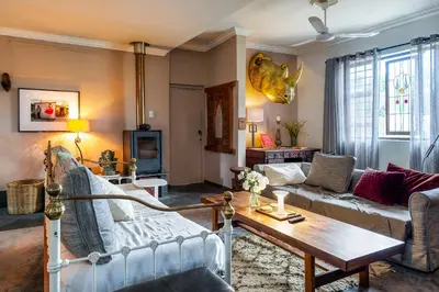 a living room with a couch and a table at The smallest farm in Africa ELGIN in Grabouw