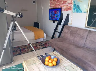 a living room with a camera and a bowl of fruit at Paradise view in Paarl