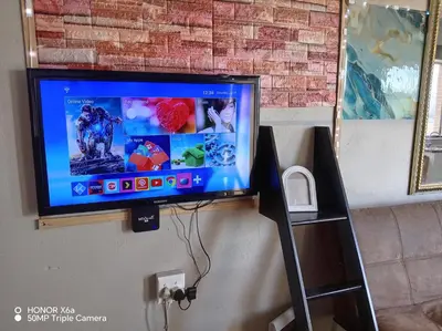 a flat screen tv hanging on a wall at Paradise view in Paarl