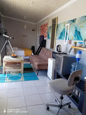 a living room with a couch and a chair at Paradise view in Paarl