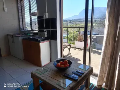 a kitchen with a bowl of fruit on a table at Paradise view in Paarl