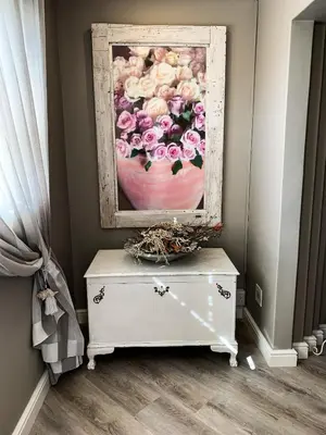 a painting of flowers on top of a dresser at PENTHOUSE Luxury Apartment Amazing Sea Views CAPE TOWN in Strand