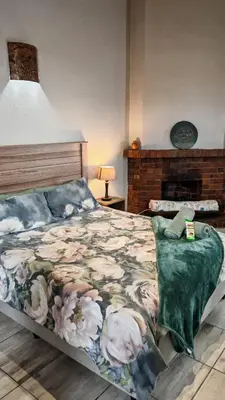 a bedroom with a bed with a blanket on it at Sunbird Studio Apartment in Brackenfell