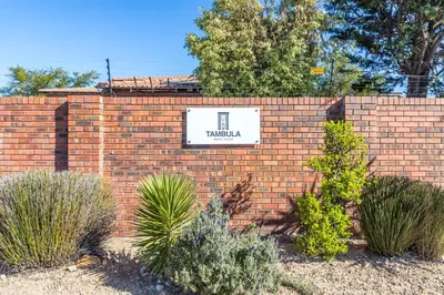 a brick wall with a sign that reads trilka at Tambula Guest House in Cape Town