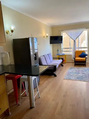 a living room with a tv and a couch at Studio Apartment 100 meters to Strand Beach in Strand