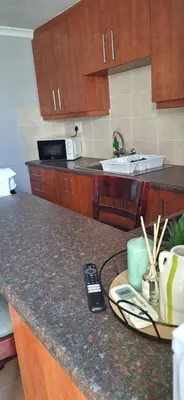 a kitchen with a counter with a remote control on it at Firehouse selfcatering Garden Cottages no 5 in Wellington