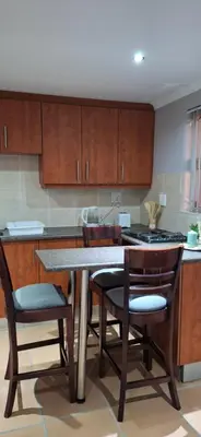 a kitchen with a table and chairs and a stove at Firehouse selfcatering Garden Cottages no 5 in Wellington