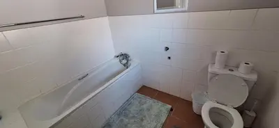 a bathroom with a tub and a toilet and a sink at Firehouse selfcatering Garden Cottages no 5 in Wellington