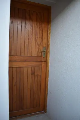 a wooden door in the corner of a room at Pualani Self Catering in Strand